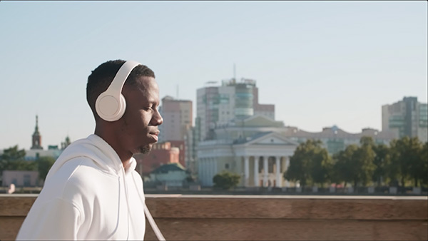 Person running in city with headphones on
