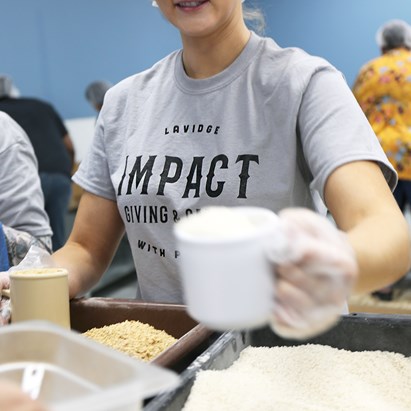 LAVDGE employees on the IMPACT volunteer and community service committee pack food for the hungry.