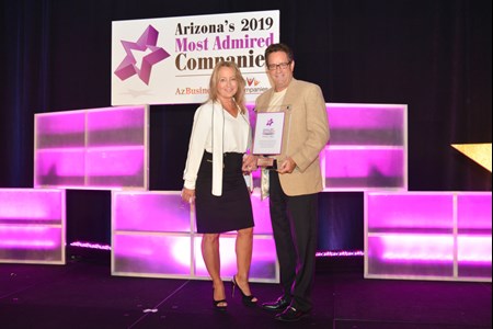 Jennifer Whittle and Dave Nobs accept an award from AZ Business Magazine honoring LAVIDGE as one of Arizona's 2019 Most Admired Companies.