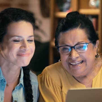 two woman looking at computer